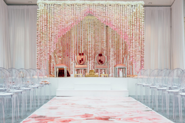 pastel Southeast Asian wedding decor with modern clear seating